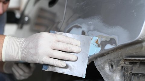 auto body repair or refinishing. Plastering the car detail before painting