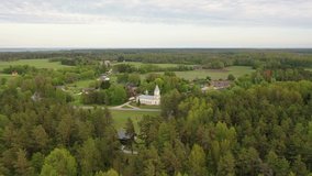 Hellamaa,Saare,Muhu Island in the Baltic Sea,Estonia. Beautiful 4K panoramic aerial video from flying drone to Orthodox Church of Sts Peter and Paul in Muhu-Hellamaa on a sunny summer day. (Series)