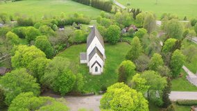 Muhu Island in the Baltic sea, Saare County, Estonia. Beautiful 4K panoramic aerial video from flying drone to Muhu St. Catherine's Church, (Muhu Katariina kirik) on a sunny summer day. (Series)
