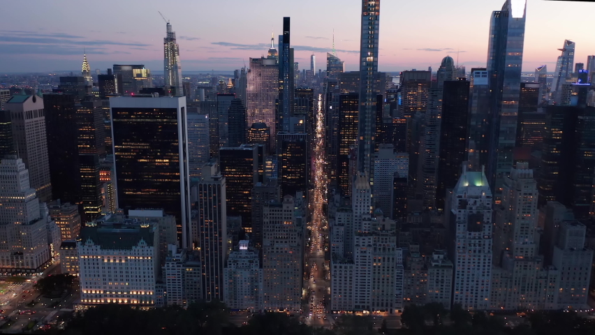 Urban Canyon in between Breathtaking Skyline endless Avenues through Manhattan, New York City Skyline at Rush Hour with Traffic at Night, Aerial Wide Shot