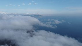 High above the thick fog, like beautiful ocean of clouds at sunrise. Sun is rising above the endless sea of clouds until the horizon. Amazing nature landscape