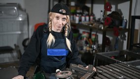 Video of caucasian girl blonde worker in work clothes posing at the factory