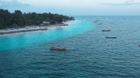 Aerial video. Indian Ocean coast at dawn, boats are on the water, beautiful coast
