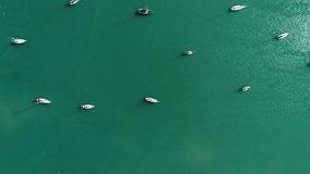 Aerial shot of anchor sailing boats on the tropical sea. Aerial view of sailing boats Top view aerial drone shot of sailing boats in harbor Beautiful sea surface