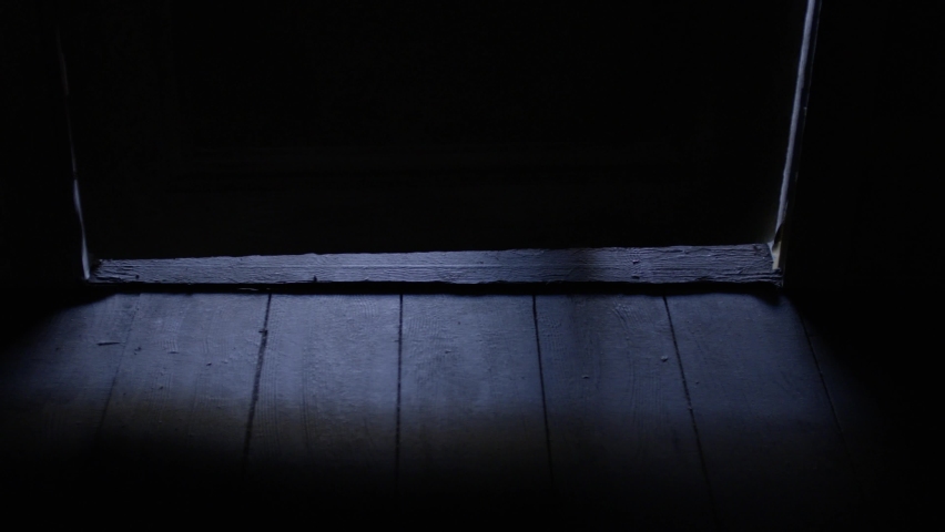 Shadow silohuette of a man under the door. Filming Red cinema camera