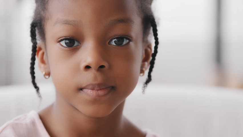 Portrait sad cute african child orphan offended afro american ethnic small girl black mixed race toddler 7 years kid looking at camera upset facial expression suffering from loneliness discrimination | Shutterstock HD Video #1071217390