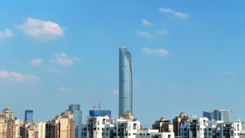 Suzhou, China - August 31, 2020: Time lapse cityscape at daytime blue sky, white clouds pass over the IFS building, downtown business financial district, Suzhou Indusrtial park, China