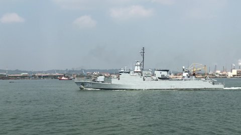 Gresik, East Java, Indonesia - April 23th 2021: The Indonesian Navy ship named KRI Fatahillah crosses the Gresik port area to the Surabaya Navy base.