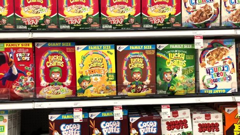 Alameda, CA - Apr 23, 2021: 4K HD video zooming in on Grocery store shelf boxes of General Mills brand cereal, Lucky Charms. regular, Honey Clovers, Chocolate and Limited Edition Magic Green Clovers.