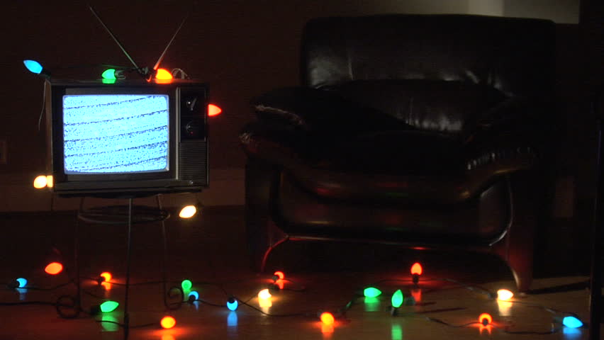 Retro TV surrounded by Christmas lights.