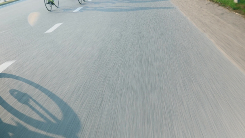 Cyclists riding on road. Silhouette of people on bikes. Professional cycling team training on road bicycles. Cycling and triathlon concept. Triathletes ride bikes. Cycling race