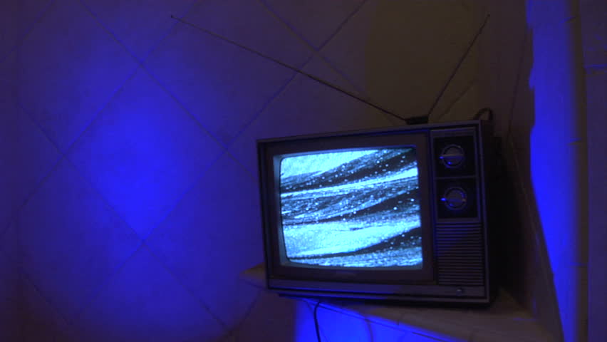 retro analog TV in a blue tile environment.