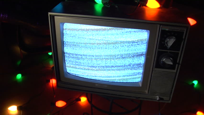 Retro TV surrounded by Christmas lights.  Interesting composition, and good