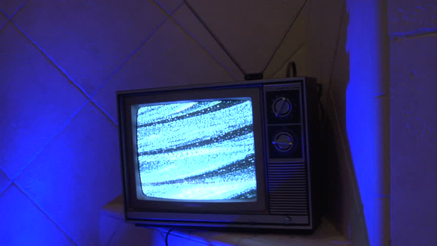 retro analog TV in a blue tile environment. The lighting slowly changes colors. 