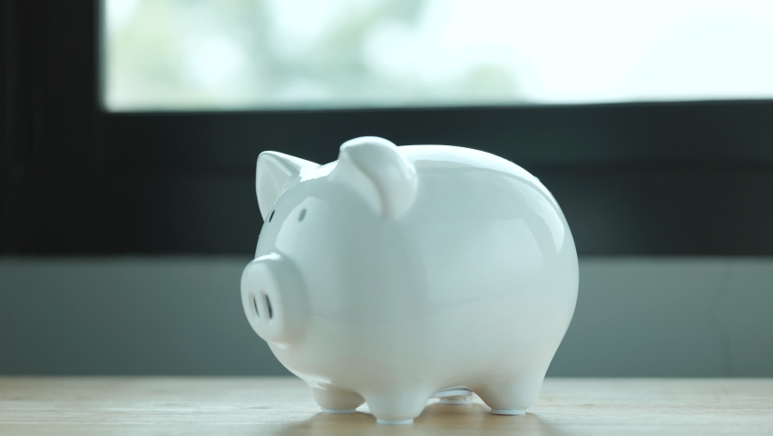 Saving money to piggy bank. Money saving concept Royalty-Free Stock Footage #1071251479