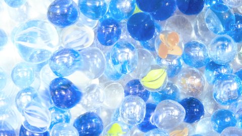 Blue and Transparent Marble Glass Balls under Waving Water, Cool Summer Image, Nobody, Fixed Shooting