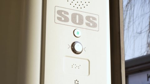 SOS signal button inside the tram, train, emergency help system push button, Braille inscription, detail, closeup Public transport safety, urban transportation security, accessibility abstract concept