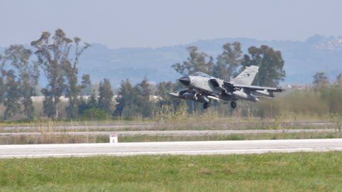 Andravida Greece APRIL, 03, 2019 Combat jet aircraft takes off in slow motion armed with full afterburner. Panavia Tornado IDS fighter bomber of Italian Air Force, Aeronautica Militare Italiana
