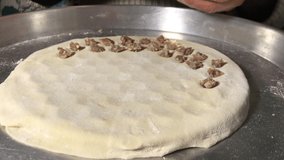 They are making handmade organic ravioli at home, opening the dough on the counter and making small small pasty by hand traditional Turkish cuisine 4K video shooting different compositions Macro buy.