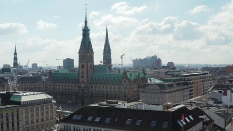 Aerial view of Hamburg city hall with green roof surrounded by traditional old buildings in city center