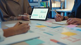 Close-up asia business people meeting plan analysis statistics brainstorm and header of team hold tablet pointing graph chart and employee take note. Finance strategy statistics success concept. - Powered by Shutterstock - Get 15% off with code: PIKWIZARD15