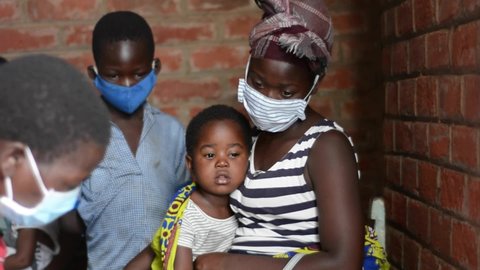 Unidentified people (some of them wearing protective mask because of the coronavirus pandemic) in the Siyaludzu Health Center (Balaka District Hospital) in Balaka, Malawi, November 2020