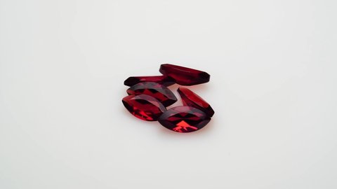 natural red garnet gemstone on the white background on the turning table