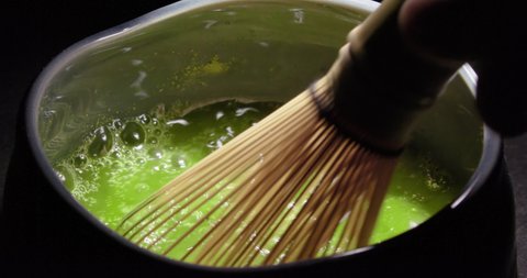 Preparing Japanese organic Matcha green tea powder with bamboo whisk, Organic product from the nature for healthy life style. Traditional Japan culture. High quality 4k footage, Slow motion.