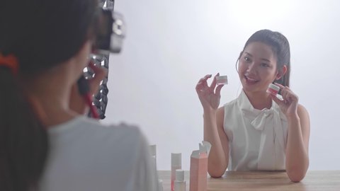 Behind The Scenes On Photo Shoot: Beautiful Asian Model Poses For A Photographer, She Takes Photos With Professional Camera
