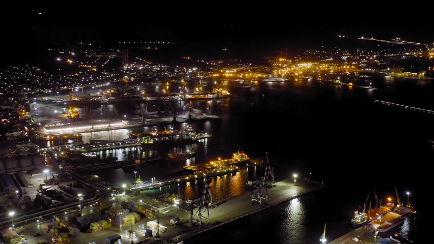 Novorossiysk, Russia. Port of Novorossiysk at night. Night city lights. Tsemesskaya Bay in the Black Sea, Aerial View