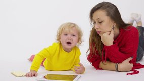 Crying little girl toddler in hysterics, angry with parents due to ban on gadgets and devices. Internet, cartoons dependence, digital world risks, psychology of the child's behavior, parenting problem