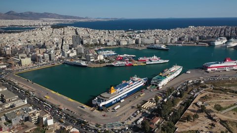 Piraeus port, Attica - Greece - April 21 2021: Aerial drone video of famous and busy port of Piraeus where passenger ships travel to popular Aegean destinations