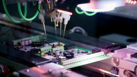 Production of electronic circuit boards. Machine for automatic installation of components on an electronic board. Manufacturing of microcircuits and microprocessors. The transistors are installed.
