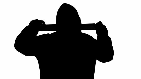 The black silhouette of a man in a hoodie, over a white background, unrolling adhesive tape, coming near the viewer and sealing its mouth or eyes. Symbolic shot (censorship).
