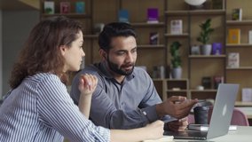 Professional indian teacher, manager or mentor helping latin student, new employee, teaching intern, explaining online job using laptop computer, talking, having teamwork discussion in office. - Powered by Shutterstock - Get 15% off with code: PIKWIZARD15