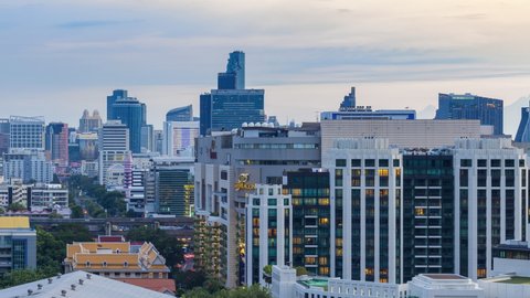 Bangkok, Thailand - 3 Sep 2020: Footage 4k Timelapse, Aerial view of cityscape Bangkok skyline car traffic, and people walking over the Pathumwan intersection, Siam square district in sunset time.
