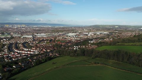 Aerial flyover of east Belfast from the countryside looking towards the city centre or center