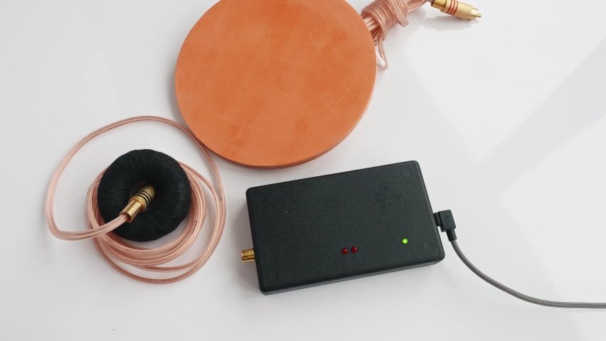 Up view of man hands fixing assembling parts of Mishin coil to start treatment procedure. Traditional medecine.