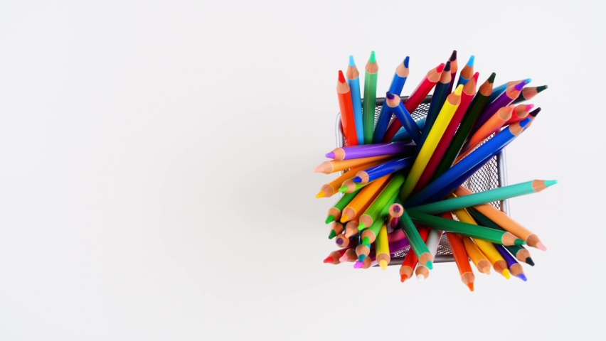 Many colored pencils standing in metal pen holder on white desk and disappears one after another from it. Top view. Stop motion animation. 4K | Shutterstock HD Video #1071331288