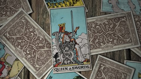 Los Angels, USA - January 30, 2021: Tarot Cards Falling. The Queen Of Swords On Stone Throne. Independent Judgement And Direct Communication. Emotional And Cold-Hearted. Divination. Fortune Reading.