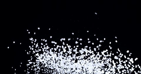 Sea salt crystals slowly fly up and fall on a black background. Blackmagic Ursa Pro G2, 300 fps.