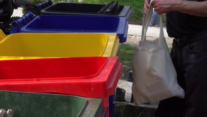 Colorful bins for sorting garbage on the street. Collection, recycling and reuse of plastic, glass, paper and metal waste, tin cans. Sustainable waste management system Royalty-Free Stock Footage #1071332872