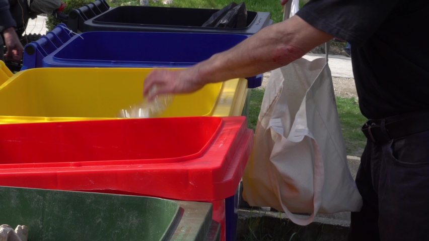 Colorful bins for sorting garbage on the street. Collection, recycling and reuse of plastic, glass, paper and metal waste, tin cans. Sustainable waste management system | Shutterstock HD Video #1071332872