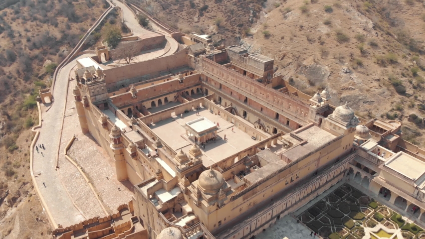 wide view of Amber Fort interior courtyard and garden in Jaipur, Rajasthan, India - Aerial Orbit Tracking shot Royalty-Free Stock Footage #1071334084