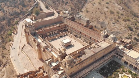 wide view of Amber Fort interior courtyard and garden in Jaipur, Rajasthan, India - Aerial Orbit Tracking shot