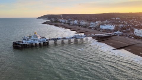 Eastbourne Pier and town at Sunset Sussex Uk Aerial pull back reveal view 4K