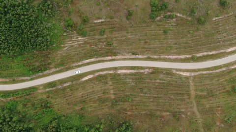 Aerial View of White Car Driving on Country Road