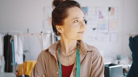 Fashion occupation. Zoom out portrait of happy proud woman designer posing at her workshop, feeling happy of her startup business, laughing with folded arms - Powered by Shutterstock - Get 15% off with code: PIKWIZARD15