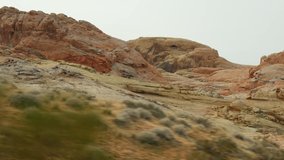Road trip, driving auto in Valley of Fire, Las Vegas, Nevada, USA. Hitchhiking traveling in America, highway journey. Red alien rock formation, Mojave desert wilderness looks like Mars. View from car. - Powered by Shutterstock - Get 15% off with code: PIKWIZARD15