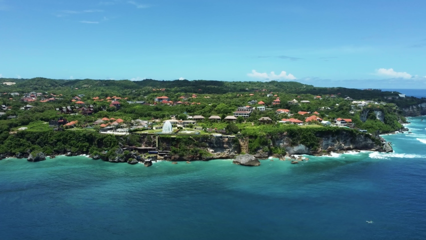 Along Uluwatu green cliff with dark blue ocean and light blue sky on Bali Indonesia. High quality aerial 4k footage | Shutterstock HD Video #1071346777